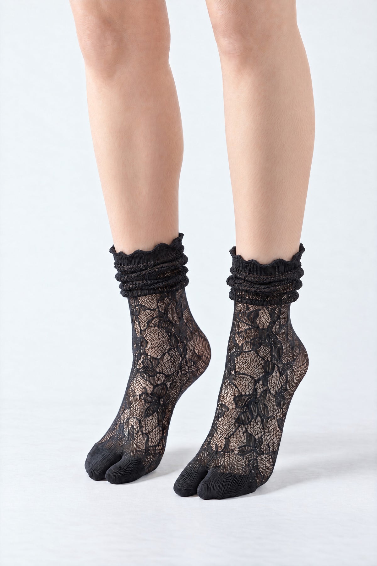 Tabi Lace Socks in black, worn scrunched down