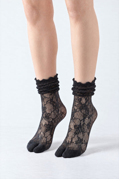 Tabi Lace Socks in black, worn scrunched down