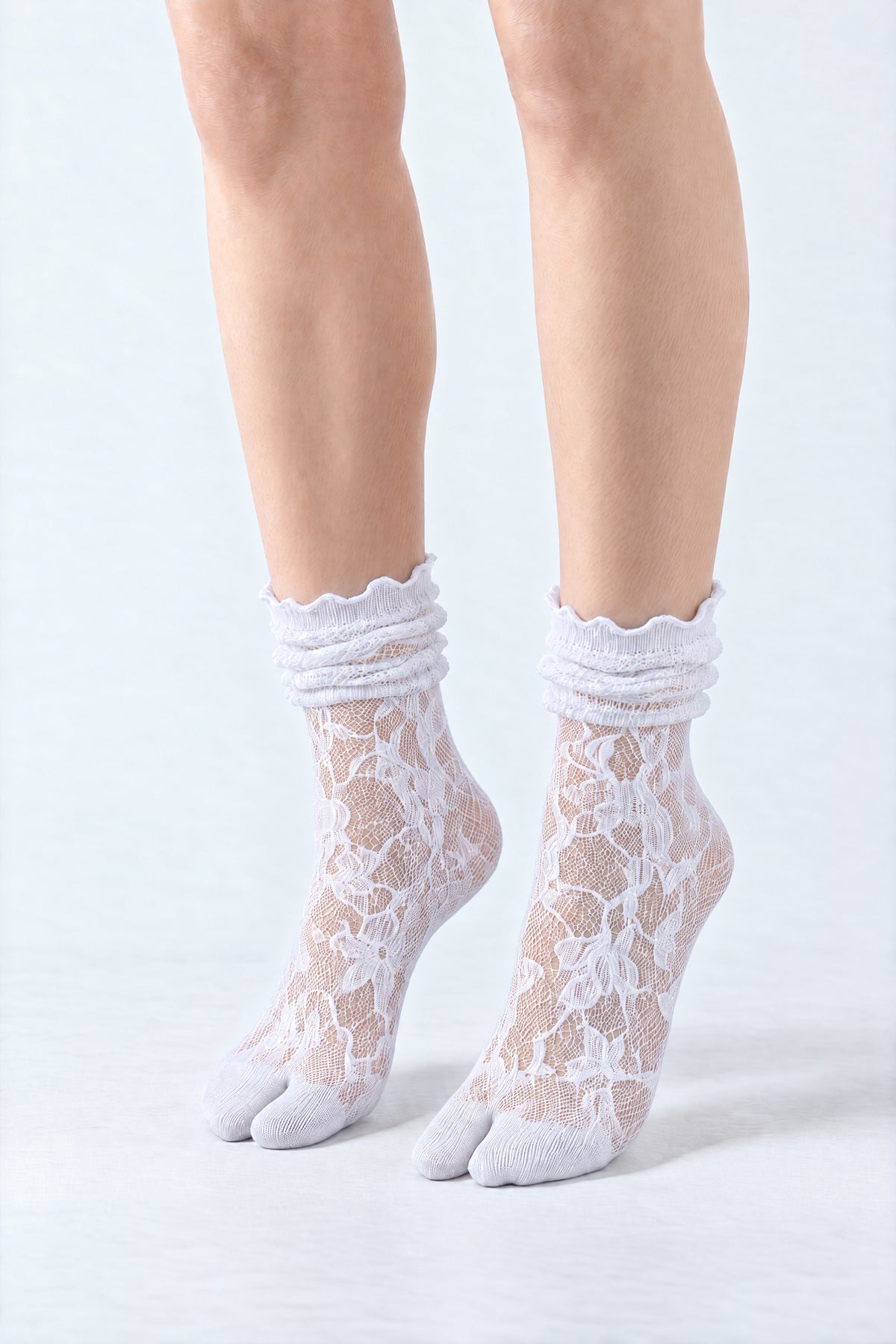 Tabi Lace Socks in white, worn scrunched down